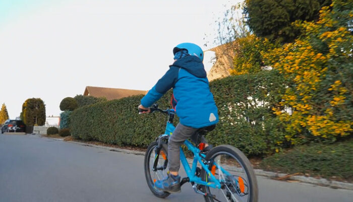 Child In The Blue Jacket Using Mountain Bike